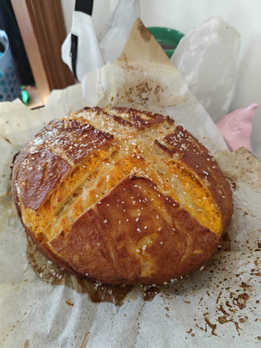 Cheddar pretzel loaf with melted cheese throughout the crust