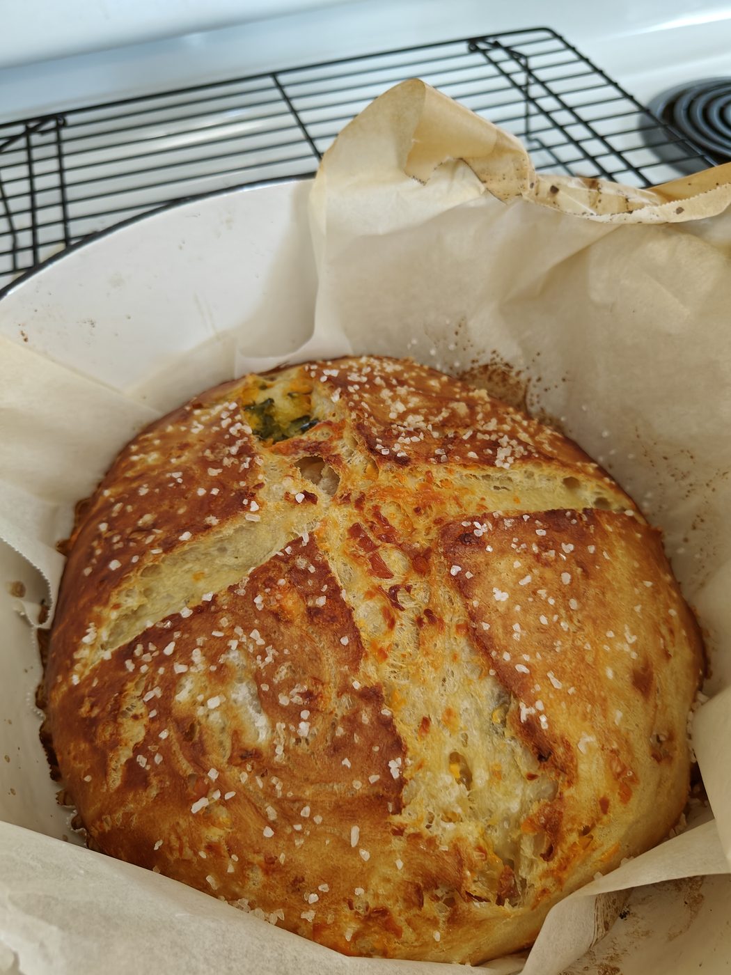 Jalapeño cheddar pretzel loaf, golden crust with cheese pulling through