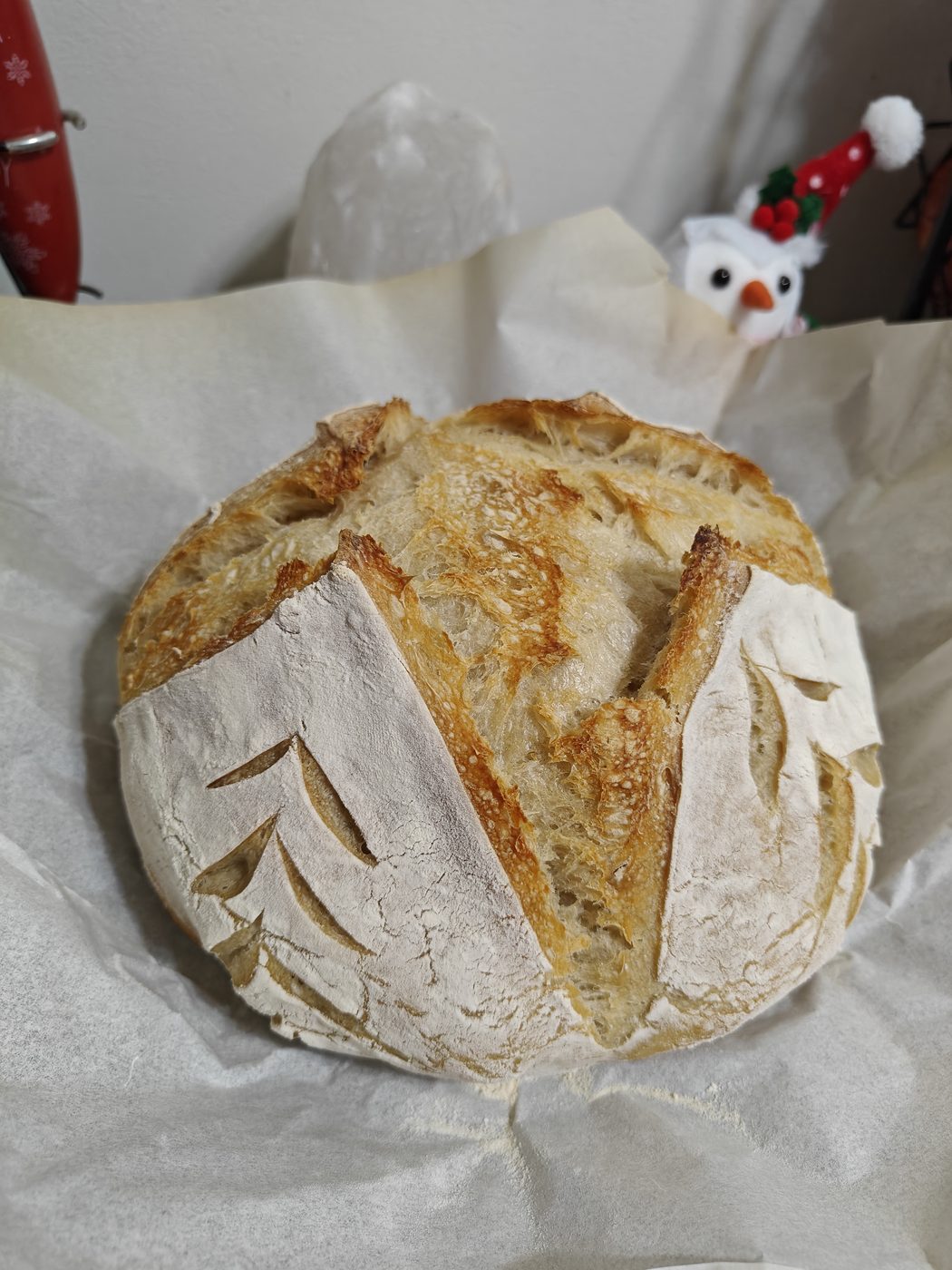 Plain sourdough loaf with a hand-scored design and golden crust